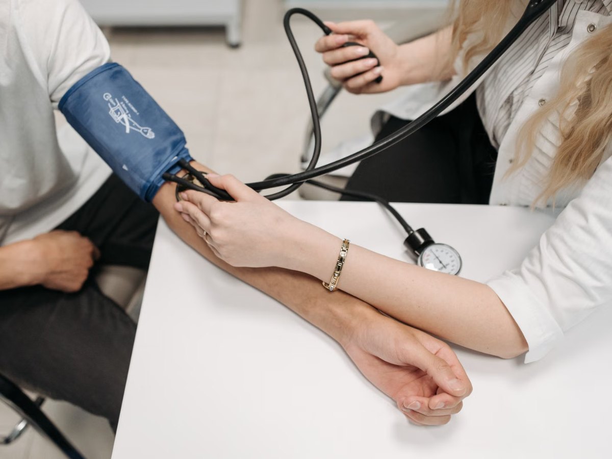 Healthcare worker checking a patient's blood pressure
